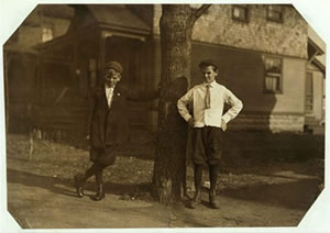 Two boys standing at a tree